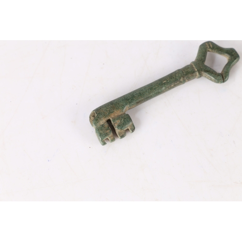 5 - AN ENGLISH MEDIEVAL KEY. With loop bow and two bits, 9cm long. 
Found in Suffolk.