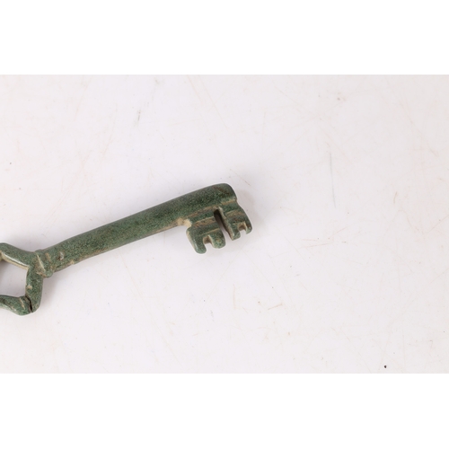 5 - AN ENGLISH MEDIEVAL KEY. With loop bow and two bits, 9cm long. 
Found in Suffolk.