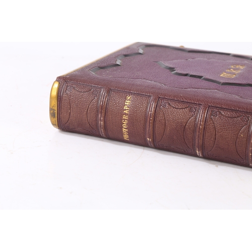 63 - A GOOD VICTORIAN CARTE DE VISITE PHOTOGRAPH ALBUM. The album with a purple tooled binding containing... 