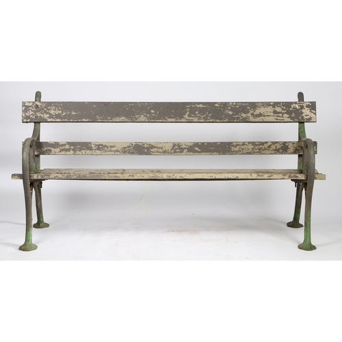 110 - A PAIR OF EDWARDIAN CAST IRON GARDEN BENCHES. the interwoven ends united by slatted backs and seats,... 