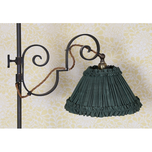 16 - A 19TH CENTURY IRON STANDARD LAMP. having scroll arm attaching to the light and a cylindrical column... 