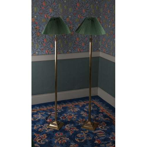 20 - A PAIR OF REGENCY STYLE BRASS STANDARD LAMPS. having a reeded column above a square base, 144cm high... 