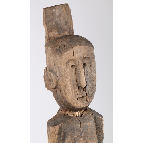 71 - A PRIMITIVE WOODEN CARVED FIGURE. Possibly Laos/ North-East Thailand, with crudely carved head and b... 