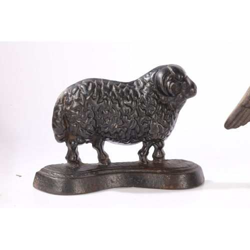 77 - THREE CAST IRON DOORSTOPS (3). consisting of a pair of rams facing left and right, 23cm wide, 16cm h... 