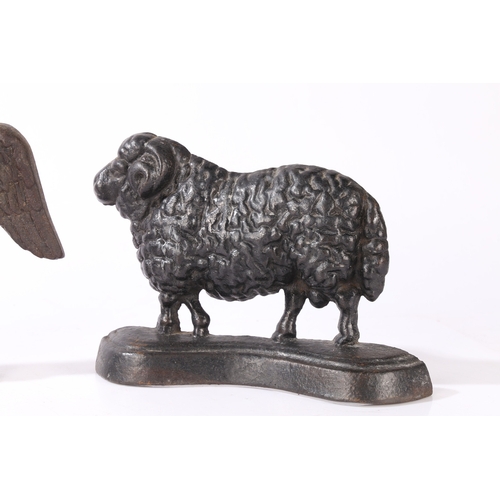 77 - THREE CAST IRON DOORSTOPS (3). consisting of a pair of rams facing left and right, 23cm wide, 16cm h... 