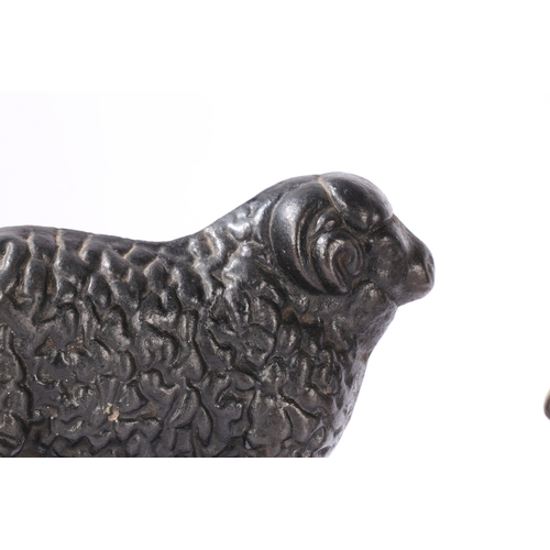 77 - THREE CAST IRON DOORSTOPS (3). consisting of a pair of rams facing left and right, 23cm wide, 16cm h... 