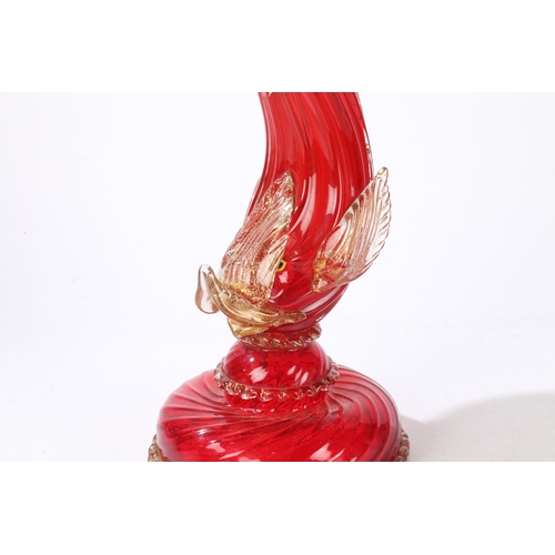 80 - A MURANO GLASS READING LAMP. modelled as a red glass dolphin with clear and gilt fins, raised on a d... 