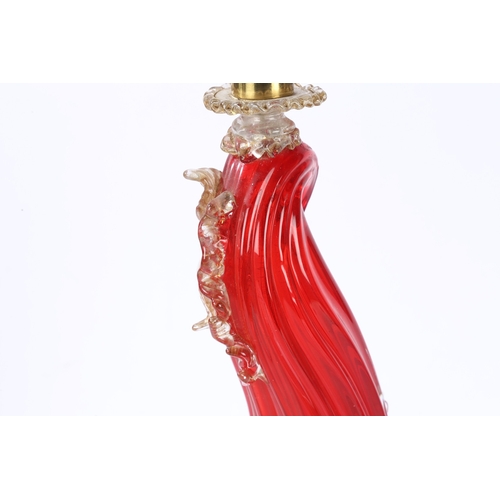 80 - A MURANO GLASS READING LAMP. modelled as a red glass dolphin with clear and gilt fins, raised on a d... 