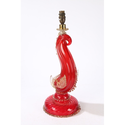 80 - A MURANO GLASS READING LAMP. modelled as a red glass dolphin with clear and gilt fins, raised on a d... 