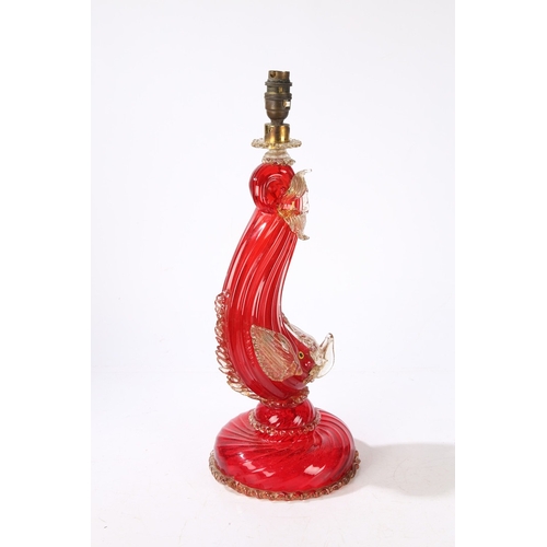 80 - A MURANO GLASS READING LAMP. modelled as a red glass dolphin with clear and gilt fins, raised on a d... 