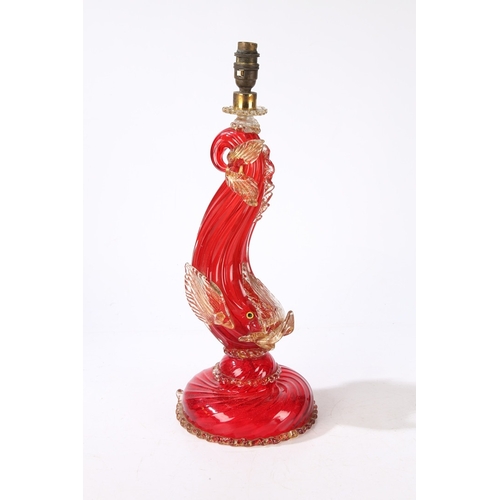 80 - A MURANO GLASS READING LAMP. modelled as a red glass dolphin with clear and gilt fins, raised on a d... 