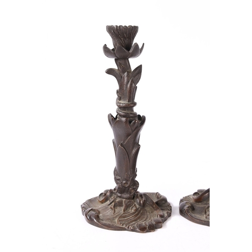 92 - A PAIR OF VICTORIAN BRONZE CANDLESTICKS. of foliate form with central entwined serpent, on a scroll ... 