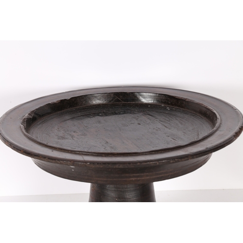 96 - A SUBSTANTIAL AFRICAN PEDESTAL BOWL. possibly Nigerian, the shallow dished circular top, raised on a... 