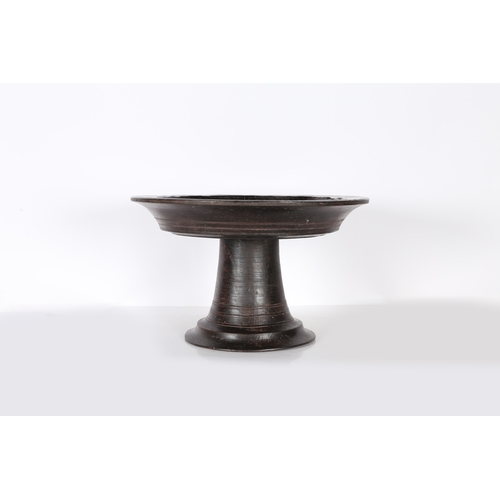 96 - A SUBSTANTIAL AFRICAN PEDESTAL BOWL. possibly Nigerian, the shallow dished circular top, raised on a... 