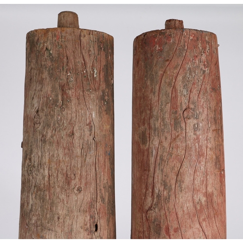 101 - A PAIR OF PINE COLUMNS. with faded red paint decoration, of tapering form with rounded bases, 174cm ... 