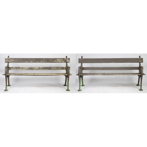 110 - A PAIR OF EDWARDIAN CAST IRON GARDEN BENCHES. the interwoven ends united by slatted backs and seats,... 