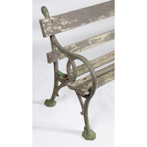 110 - A PAIR OF EDWARDIAN CAST IRON GARDEN BENCHES. the interwoven ends united by slatted backs and seats,... 