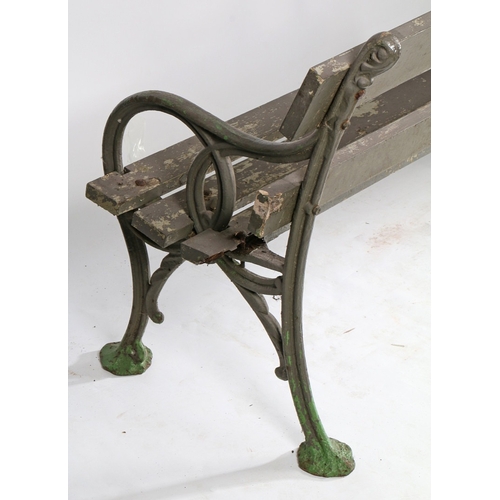 110 - A PAIR OF EDWARDIAN CAST IRON GARDEN BENCHES. the interwoven ends united by slatted backs and seats,... 