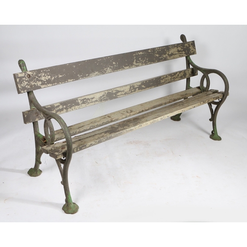 110 - A PAIR OF EDWARDIAN CAST IRON GARDEN BENCHES. the interwoven ends united by slatted backs and seats,... 