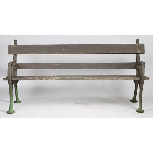 110 - A PAIR OF EDWARDIAN CAST IRON GARDEN BENCHES. the interwoven ends united by slatted backs and seats,... 