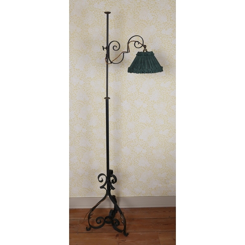 16 - A 19TH CENTURY IRON STANDARD LAMP. having scroll arm attaching to the light and a cylindrical column... 