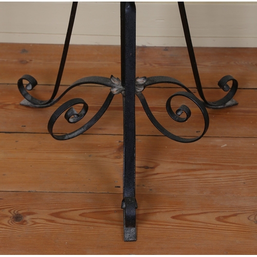 18 - A 19TH CENTURY IRON STANDARD LAMP. having scroll supports above a cylindrical column with floral mot... 