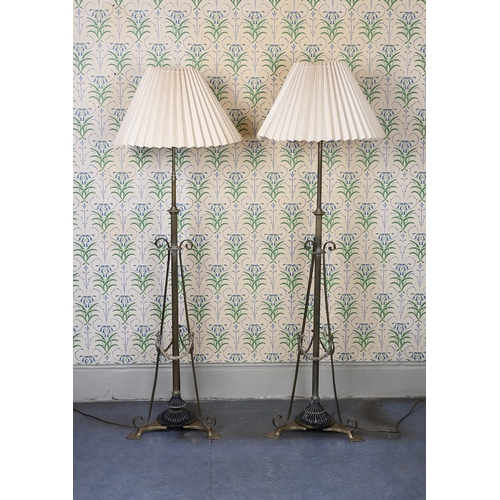 19 - A PAIR OF REGENCY STYLE BRASS ADJUSTABLE STANDARD LAMPS. having a reeded column with scroll supports... 