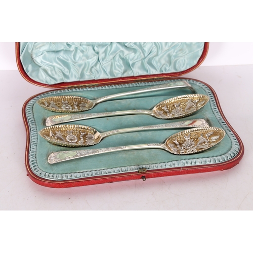 285 - A SET OF FOUR VICTORIAN SILVER BERRY SPOONS. London 1899, maker RS, with gilt foliate embossed bowls... 