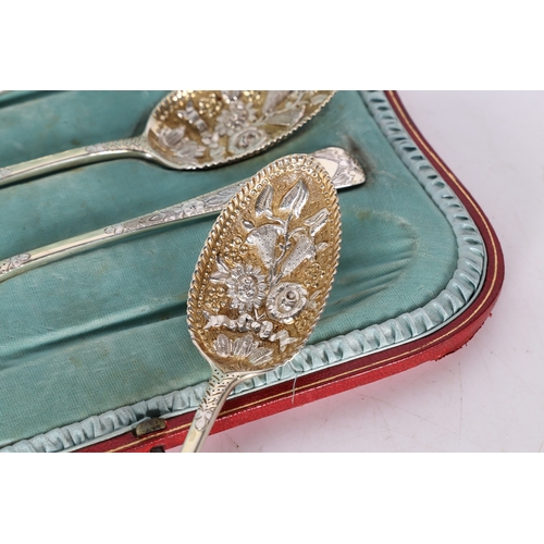 285 - A SET OF FOUR VICTORIAN SILVER BERRY SPOONS. London 1899, maker RS, with gilt foliate embossed bowls... 