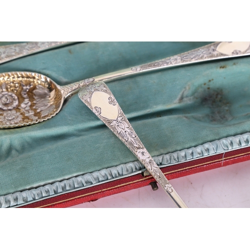 285 - A SET OF FOUR VICTORIAN SILVER BERRY SPOONS. London 1899, maker RS, with gilt foliate embossed bowls... 