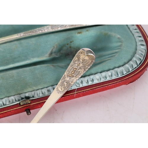 285 - A SET OF FOUR VICTORIAN SILVER BERRY SPOONS. London 1899, maker RS, with gilt foliate embossed bowls... 