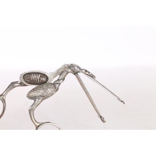 287 - A PAIR OF 19TH CENTURY WHITE METAL RIBBON THREADERS/ SCISSORS. in the form of a stork carrying a swa... 