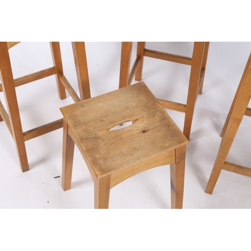 32 - ANDREW BECKWITH FURNITURE, A PAIR OF HIGH STOOLS AND A LOW STOOL. having a square seat with an ellip... 