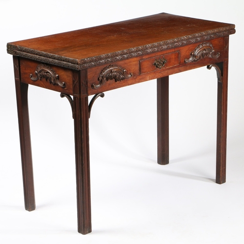 320 - AN EARLY GEORGE III CARVED MAHOGANY CARD TABLE. The hinged rectangular top opening to reveal a toole... 