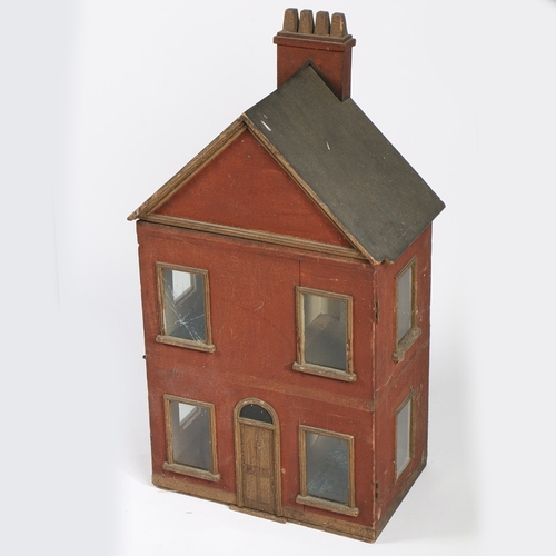 326 - A 19TH CENTURY DOLLS HOUSE. The apex roof with a four chimney stack above a red body with two window... 