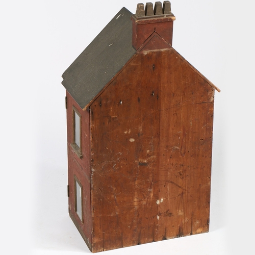 326 - A 19TH CENTURY DOLLS HOUSE. The apex roof with a four chimney stack above a red body with two window... 