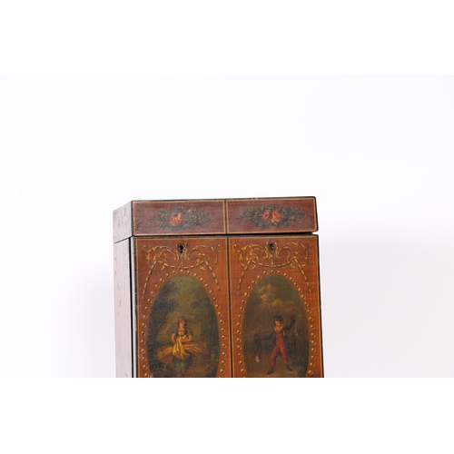 327 - A REGENCY SATINWOOD AND POLYCHROME PAINTED TABLE CABINET. modelled as a stylised wardrobe, the ebony... 