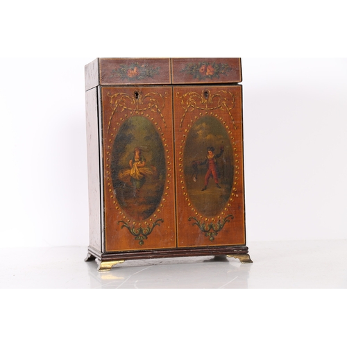 327 - A REGENCY SATINWOOD AND POLYCHROME PAINTED TABLE CABINET. modelled as a stylised wardrobe, the ebony... 