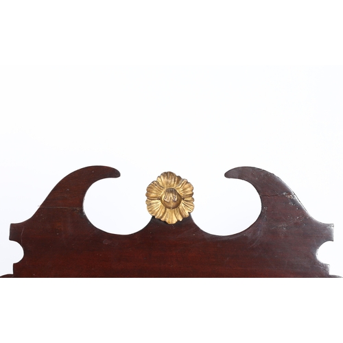 335 - A GEORGE II STYLE MAHOGANY FRET MIRROR. the scrolled pediment with central gilt flowerhead, the shap... 