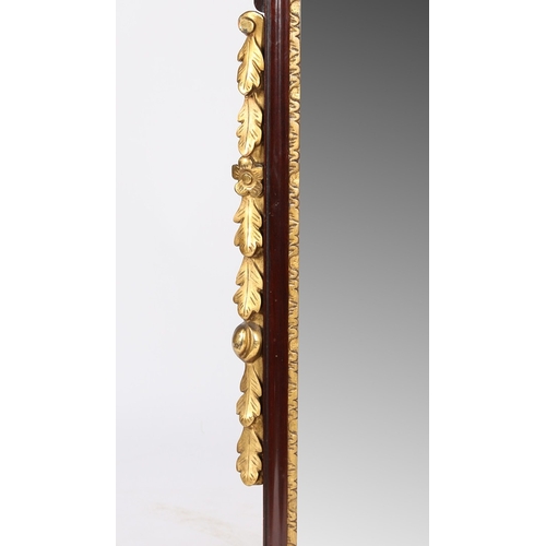 335 - A GEORGE II STYLE MAHOGANY FRET MIRROR. the scrolled pediment with central gilt flowerhead, the shap... 