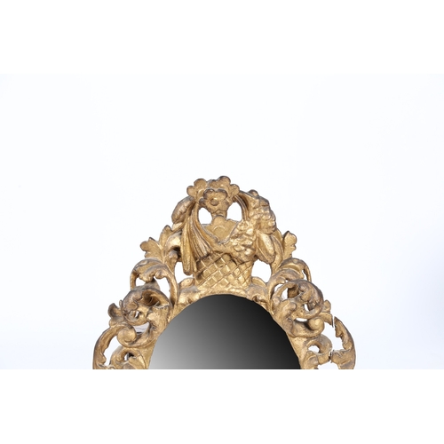 344 - A 19TH CENTURY FRENCH GILT WALL MIRROR. the oval mirror plate housed in a pierced foliate and scroll... 