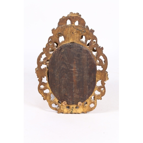 344 - A 19TH CENTURY FRENCH GILT WALL MIRROR. the oval mirror plate housed in a pierced foliate and scroll... 