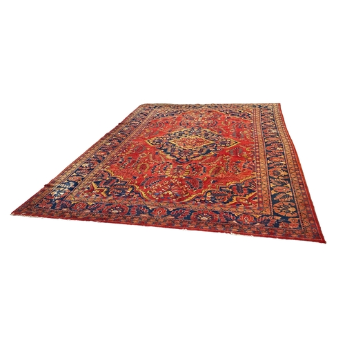 357 - A HAMADAN CARPET. A Hamadan Carpet, the blood red field of flowering plants centred by an indigo med... 