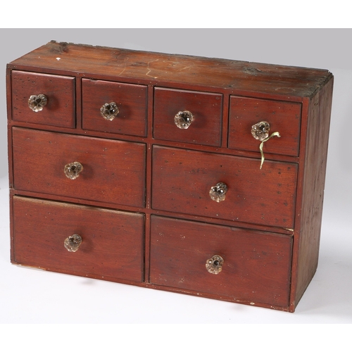 358 - A DARK STAINED PINE BANK OF EIGHT APOTHECARY DRAWERS. arranged as four short drawers above two rows ... 