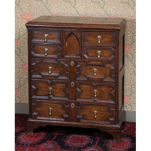 38 - A GEORGE III OAK EAST ANGLIAN GEOMETRIC CHEST OF DRAWERS. having a three plank top above four short ... 