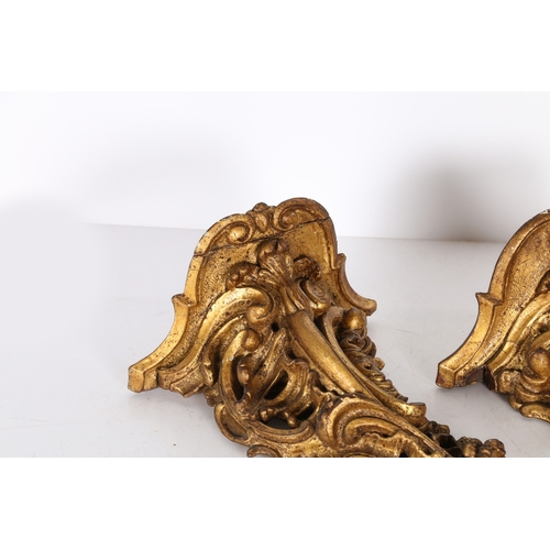 382 - A PAIR OF ROCOCO GILT WOOD BRACKETS. the scroll fronted shelved above pierced foliate and scroll dec... 