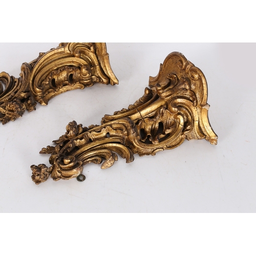 382 - A PAIR OF ROCOCO GILT WOOD BRACKETS. the scroll fronted shelved above pierced foliate and scroll dec... 