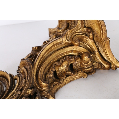 382 - A PAIR OF ROCOCO GILT WOOD BRACKETS. the scroll fronted shelved above pierced foliate and scroll dec... 