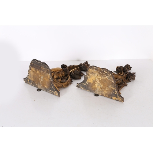 382 - A PAIR OF ROCOCO GILT WOOD BRACKETS. the scroll fronted shelved above pierced foliate and scroll dec... 