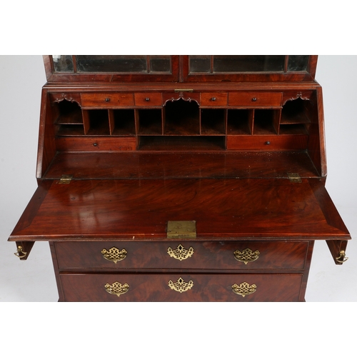 388 - A GEORGE III MAHOGANY BUREAU BOOKCASE. With dentil and blind fret carved pediment, the upper section... 